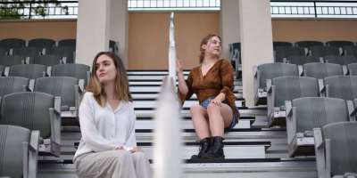 women sitting on the bleacher stairs